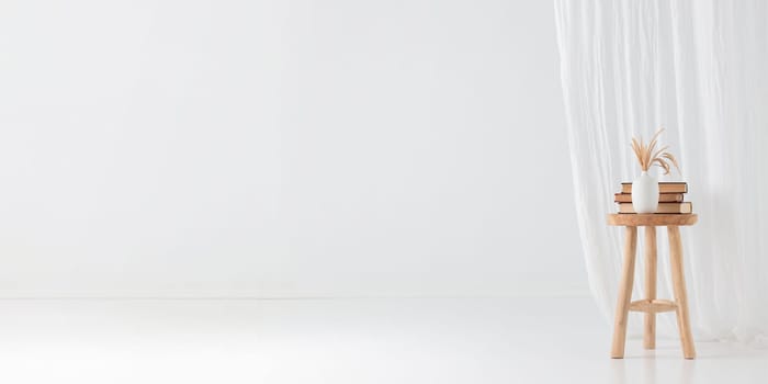 Wooden handcraft chair with books and vase on a white background