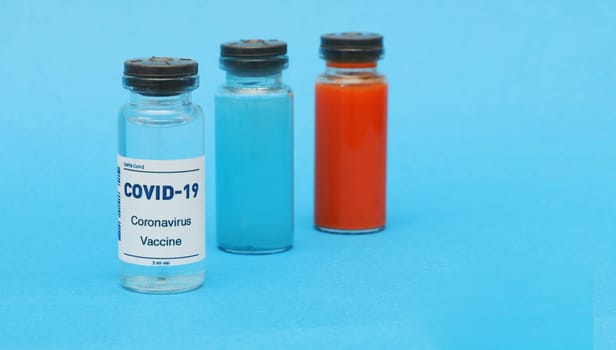 Glass bottle with covid-19 vaccine, blood bottle, blue liquid bottle.