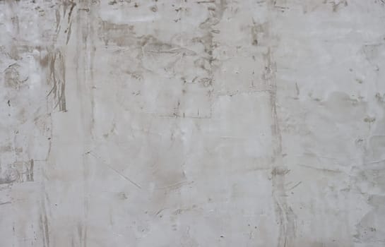 Grey plaster painted wall with rough grungy surface texture background.