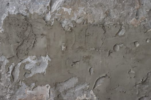 The wall is covered with rough putty. Abstract background of a gray concrete wall unevenly plastered and covered with cement.....