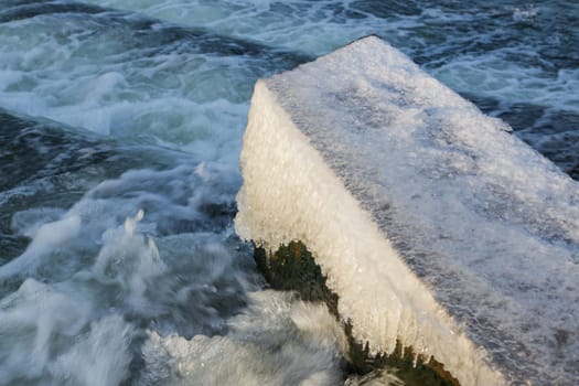 Water Cascading over Weir Step in river canal.