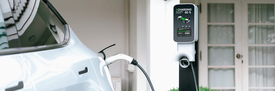 Electric vehicle technology utilized to residential home charging station for EV car battery recharge. Eco-friendly transport by clean and sustainable energy for future environment.Panorama Synchronos
