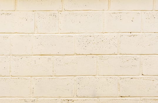 freshly painted wall structure made of light beige foam concrete blocks, texture of a wall fragment with many rows of blocks, High quality photo