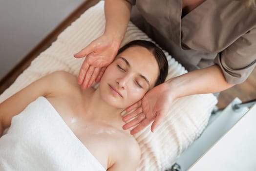 Young female getting spa skin care massage in beauty salon