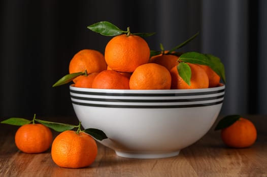 fresh juicy tangerines in a bowl on the table