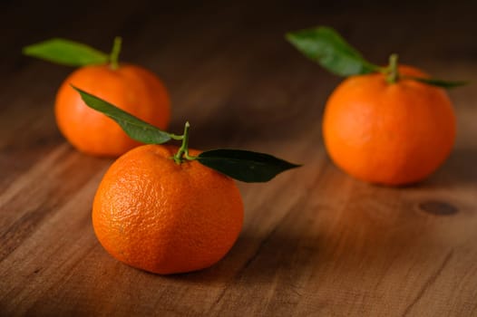 fresh juicy three tangerines on a wooden table 6