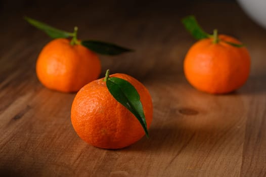 fresh juicy three tangerines on a wooden table 5