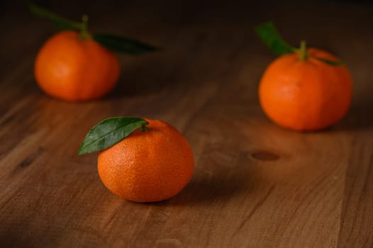 fresh juicy three tangerines on a wooden table 8