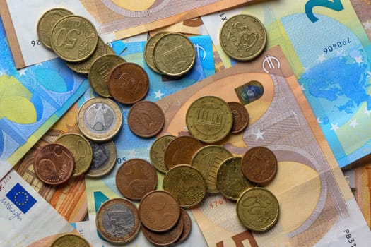 Euro bills and coins scattered on the table as a background 6