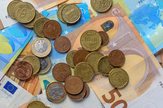 Euro bills and coins scattered on the table as a background 4