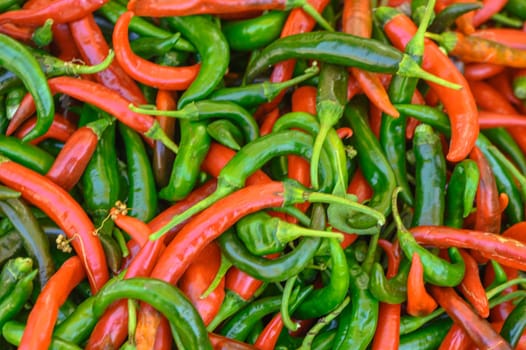 fresh appetizing red and green hot peppers at the bazaar on the island of Cyprus in autumn