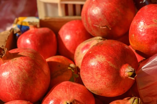 beautiful fresh pomegranates in a pile at a local market in the mediterranean