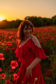 Woman poppy field red dress sunset. Happy woman in a long red dress in a beautiful large poppy field. Blond stands with her back posing on a large field of red poppies.