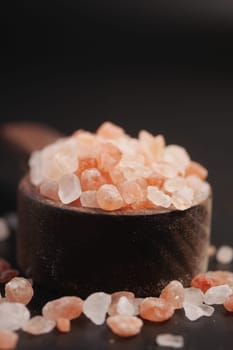 Raw dried pink Himalayan salt in a spoon .