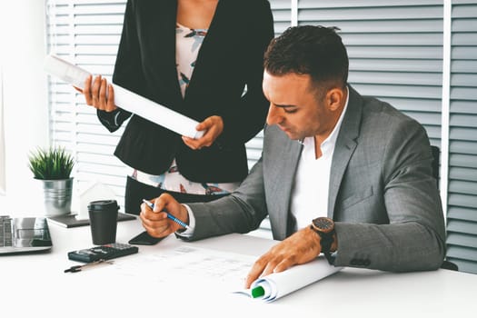 Businessman executive checking work while meeting discussion with businesswoman worker in modern workplace office. People corporate business team concept. uds