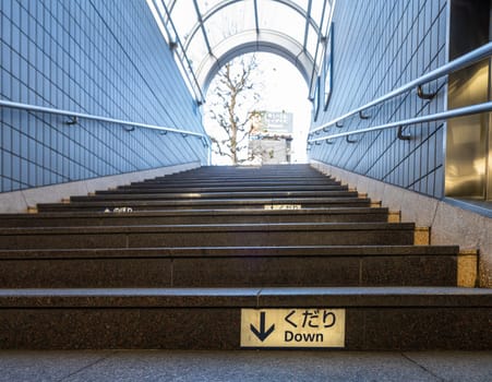 Tokyo, Japan, January 2024.  the steps of the staircase at the entrance of a subway station in the city center