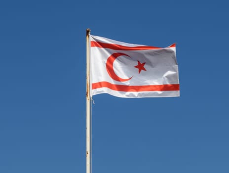 Northern Cyprus flag against blue sky