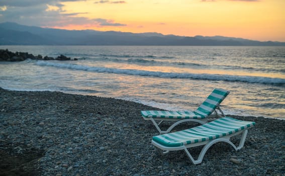 sun loungers on the beach at sunset on the Mediterranean Sea in Northern Cyprus