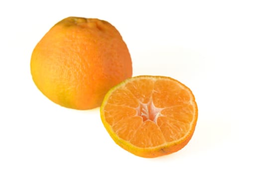 fresh appetizing half tangerine and whole tangerine on a white background