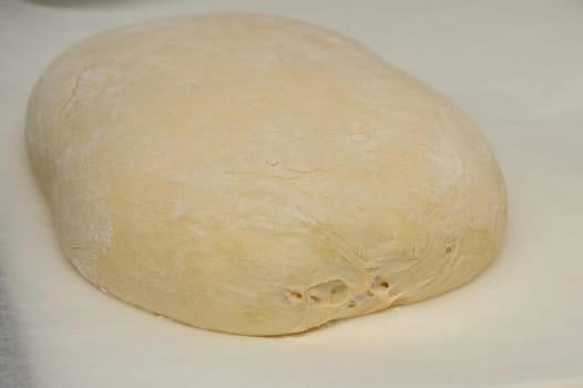 dough for homemade bread lies on the kitchen table before going into the oven 12