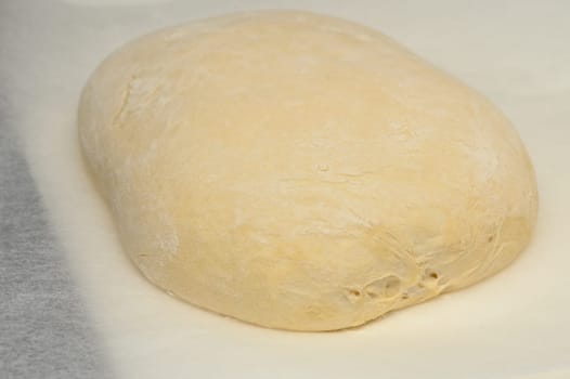 dough for homemade bread lies on the kitchen table before going into the oven 14