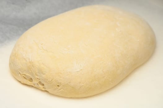 dough for homemade bread lies on the kitchen table before going into the oven 16