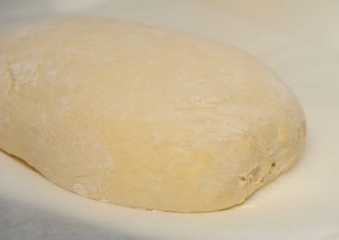 dough for homemade bread lies on the kitchen table before going into the oven 4