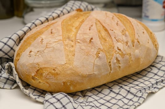 freshly baked homemade bread on the kitchen table on a light background 14