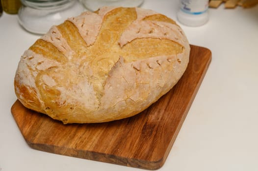 freshly baked homemade bread on the kitchen table on a light background 8