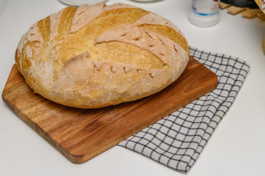 freshly baked homemade bread on the kitchen table on a light background 7