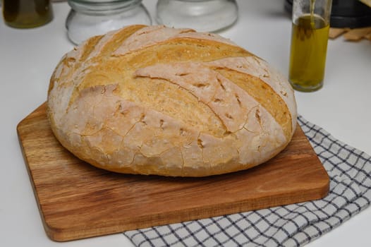freshly baked homemade bread on the kitchen table on a light background 6