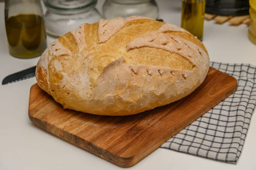 freshly baked homemade bread on the kitchen table on a light background 4