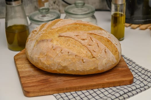 freshly baked homemade bread on the kitchen table on a light background