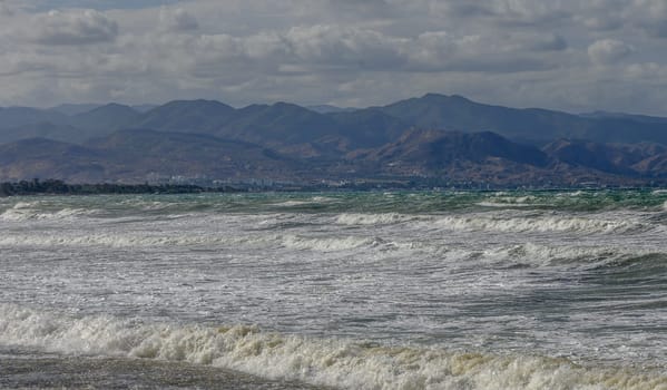 view of the waves in the Mediterranean Sea and mountains in autumn on the island of Cyprus