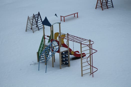 Children's playground on the snowy ground
