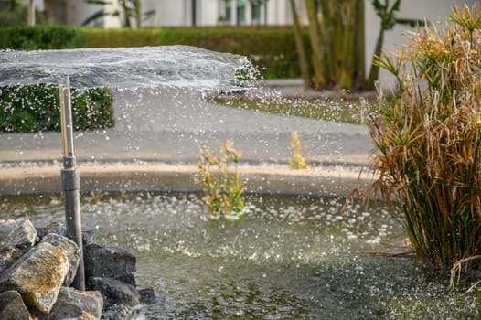 a fountain sprays water against the backdrop of a residential complex near the sea 9