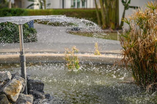 a fountain sprays water against the backdrop of a residential complex near the sea 8