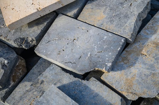 pieces of stone for paving lie in a heap as a background 10