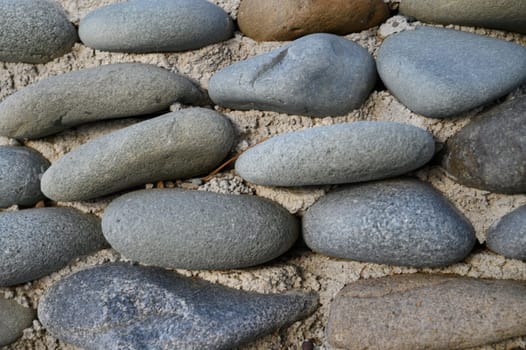 sea ​​pebbles with concrete as background