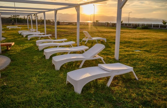 white plastic sun loungers on the Mediterranean sea 6