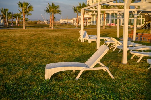 white plastic sun loungers on the Mediterranean sea 2