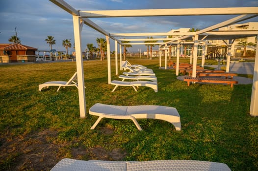 white plastic sun loungers on the Mediterranean sea 1