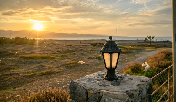 lantern on the fence at sunset