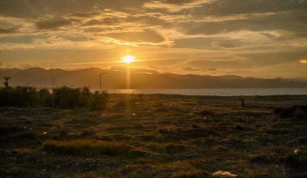 garbage near a residential complex against the backdrop of the setting sun