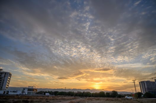 sunset sky on the island of Cyprus, colorful clouds and reflections in the sky