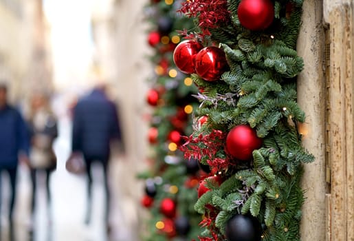 Christmas street decor. Christmas balls on tree branches on winter city streets. Soft focus. Christmas in Europe.