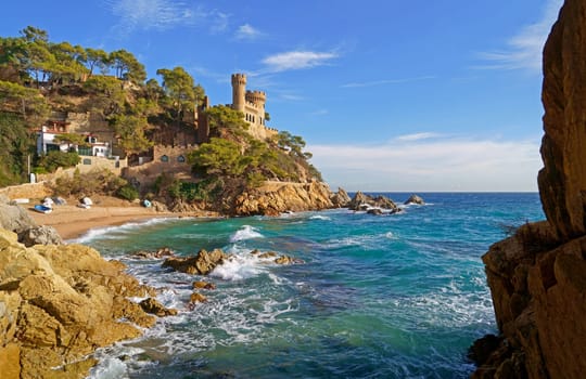Spain. Coast of the Costa Brava. Catalonia. Lloret de Mar. Mediterranean Sea. Beautiful rocks. A sea wave hits the shore.