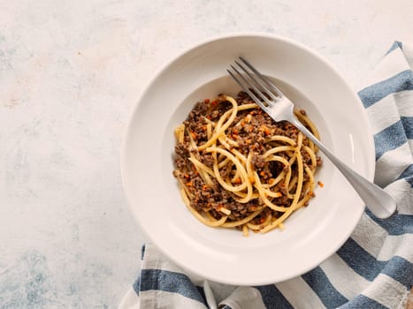 Spaghetti bolognese with minced meat or Makarony Po Flotski or Russian Navy Style Pasta. Top view. Navy spaghetti in plate, copy space.