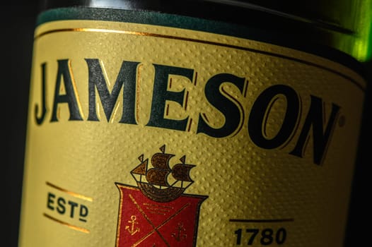 Ukraine, Chernigov 18/11/2023 - Bottle of Jameson whiskey on a black background, beautiful color of whiskey 1