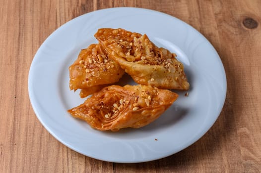 Turkish baklava, sweet dessert with honey on a light plate